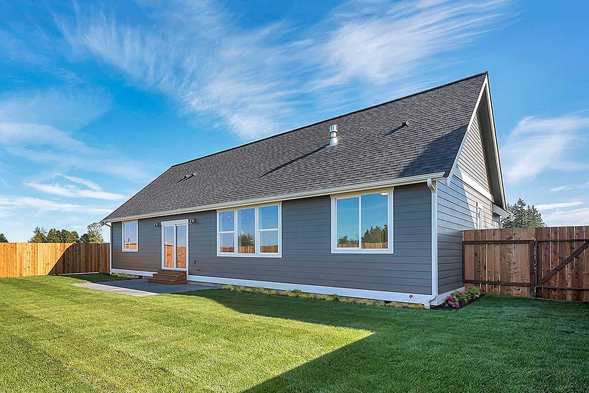 House plan exterior: Single-story home with gray siding, gabled roof, and multiple windows.