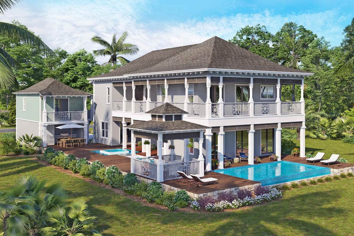 House plan exterior: two-story home with wraparound porches, multiple gables, and detached garage structure.