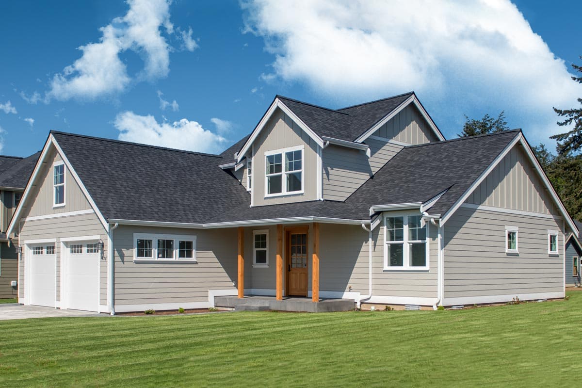 House plan exterior with Craftsman style, two stories, gabled roof, front porch, and garage with two bays.
