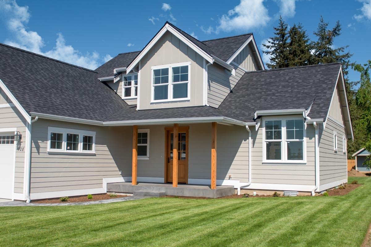 House plan exterior of a two-story home with a covered front porch, gables, and horizontal siding.