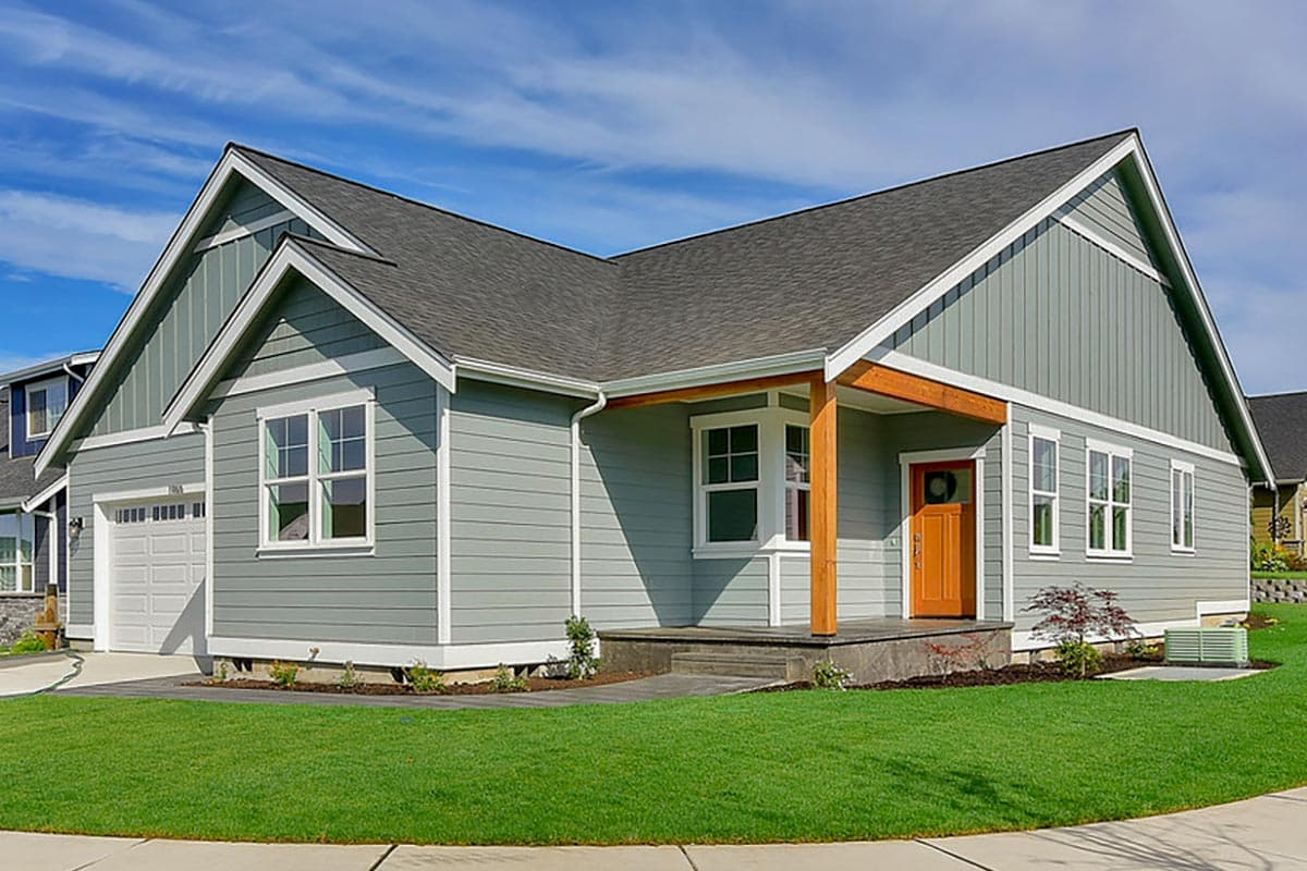 House plan exterior. Craftsman style, one-story home with a gabled roof, covered porch with wooden supports, and an attached garage.