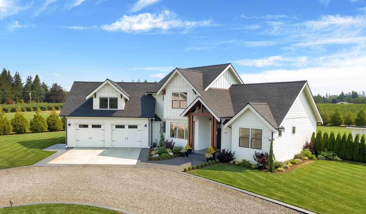 Modern Farmhouse house plan exterior with a two-car garage, gabled dormers, and a covered entry with wood beams.