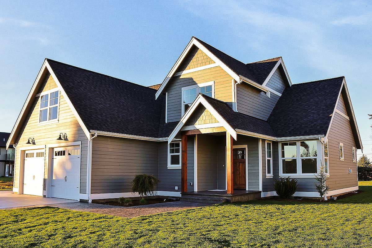 House plan exterior featuring a two-story Craftsman style home with gables, a covered porch, and a side-entry garage.