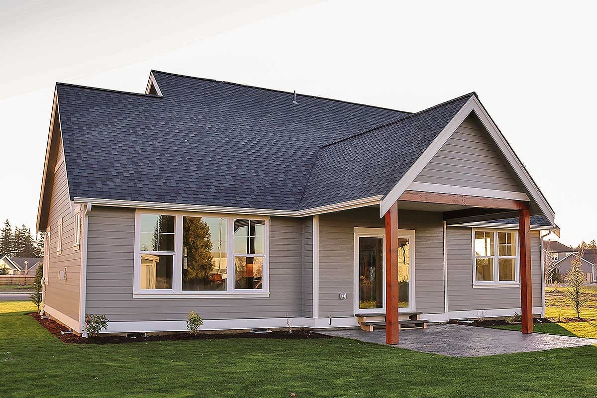 House plan exterior: Single-story Modern Farmhouse with gabled roof, covered patio, and multiple large windows.