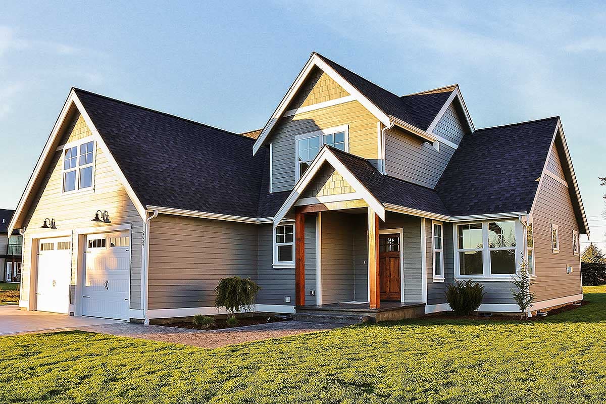 House plan exterior featuring a two-car garage, covered entry with wooden posts, and multiple gables with dormers.