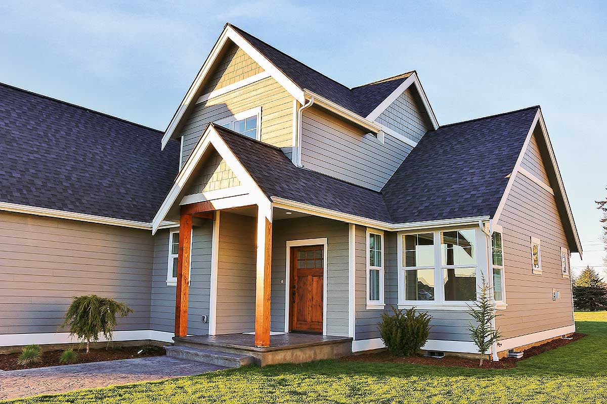 House plan exterior with covered entry, gabled rooflines, and horizontal siding.