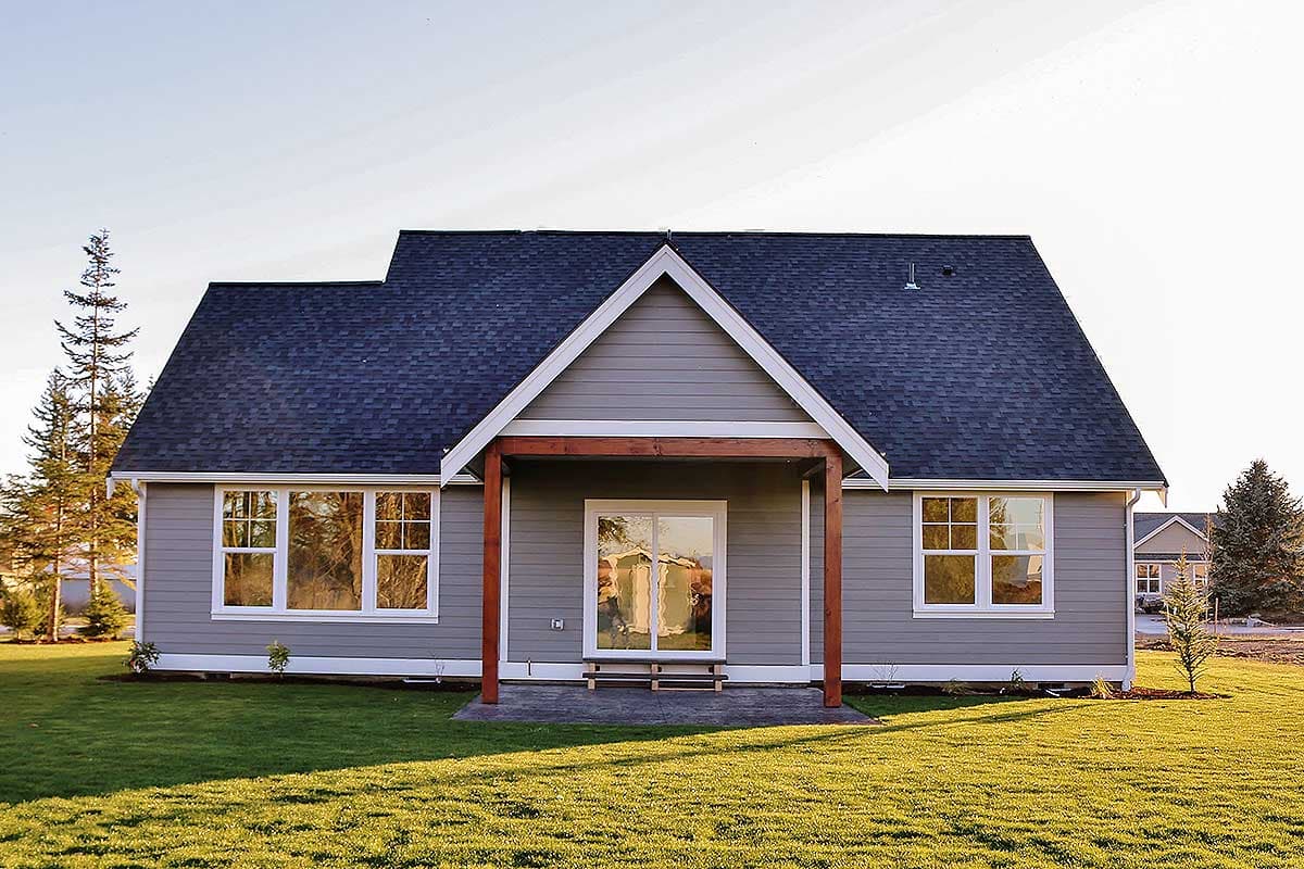 House plan exterior featuring a one-story Modern Farmhouse style with a covered entry, gables, and multiple windows.