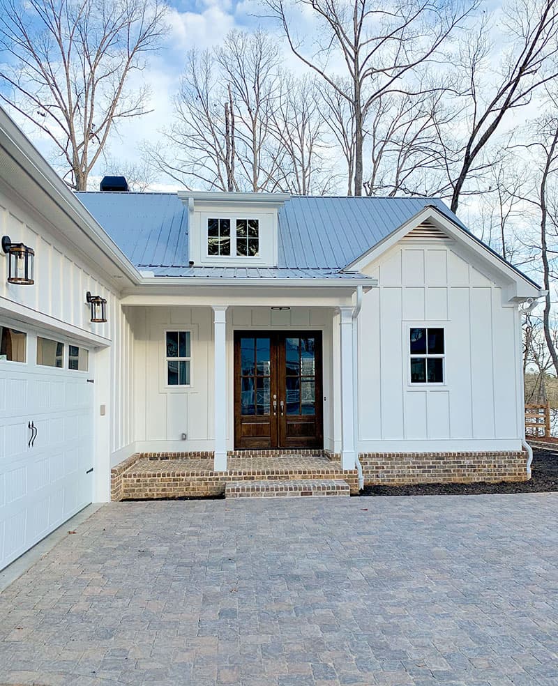 Modern Farmhouse house plan exterior with metal roof, dormer, board and batten siding, and attached garage.