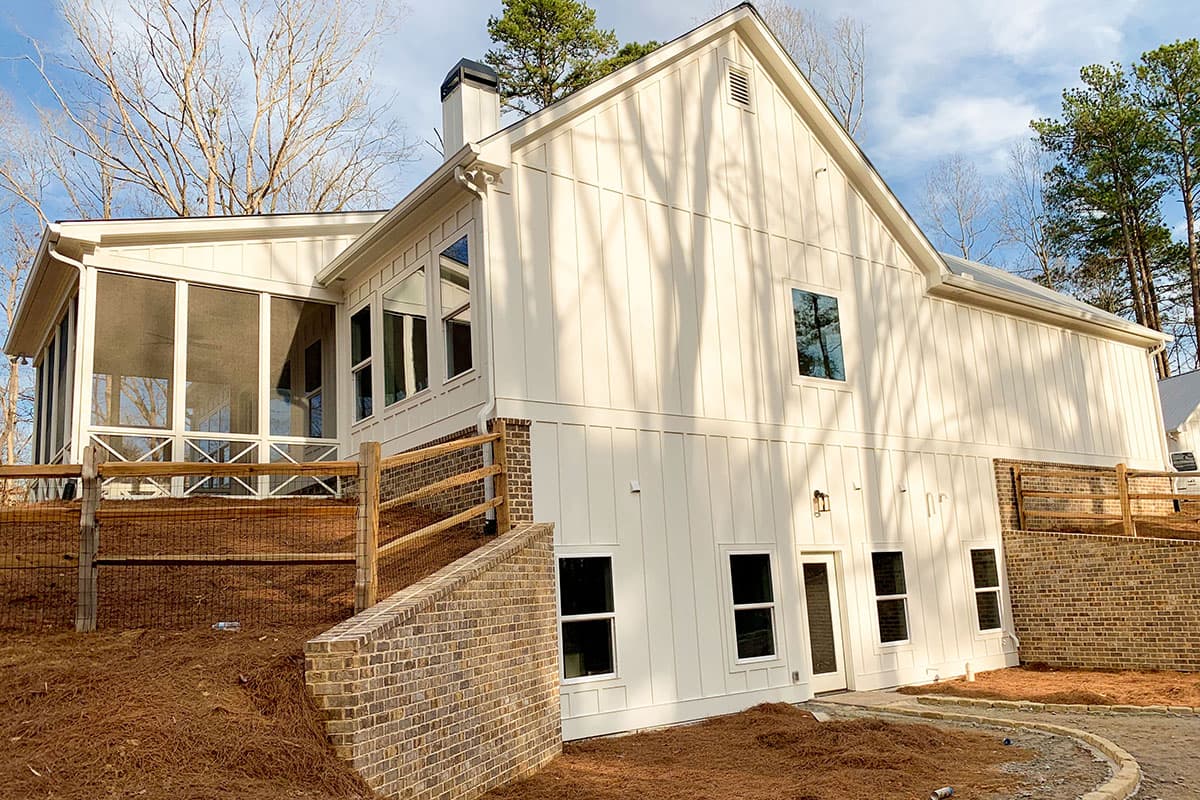 Modern Farmhouse house plan exterior with vertical siding, gabled roof, screened porch, and brick accents.