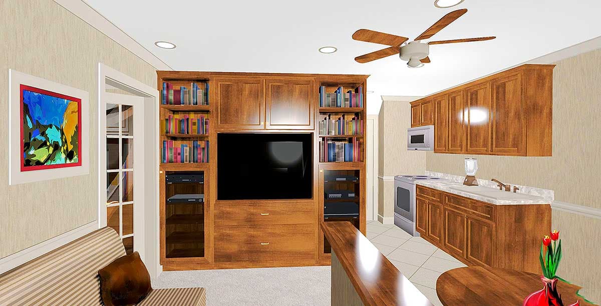 Interior view showing a built-in entertainment center with shelving, a kitchen area with wood cabinets, and a ceiling fan.