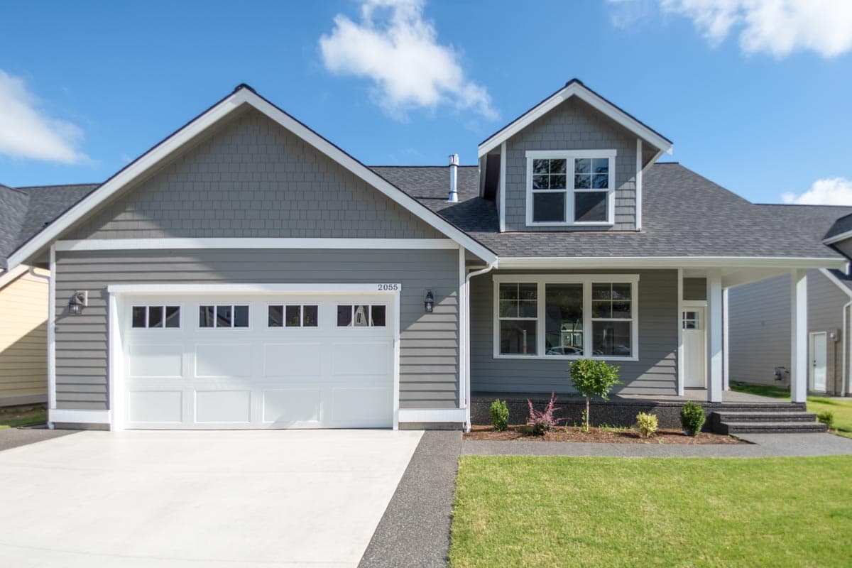 House plan exterior: Two-story Modern Farmhouse with attached garage, front porch, and gable dormer.