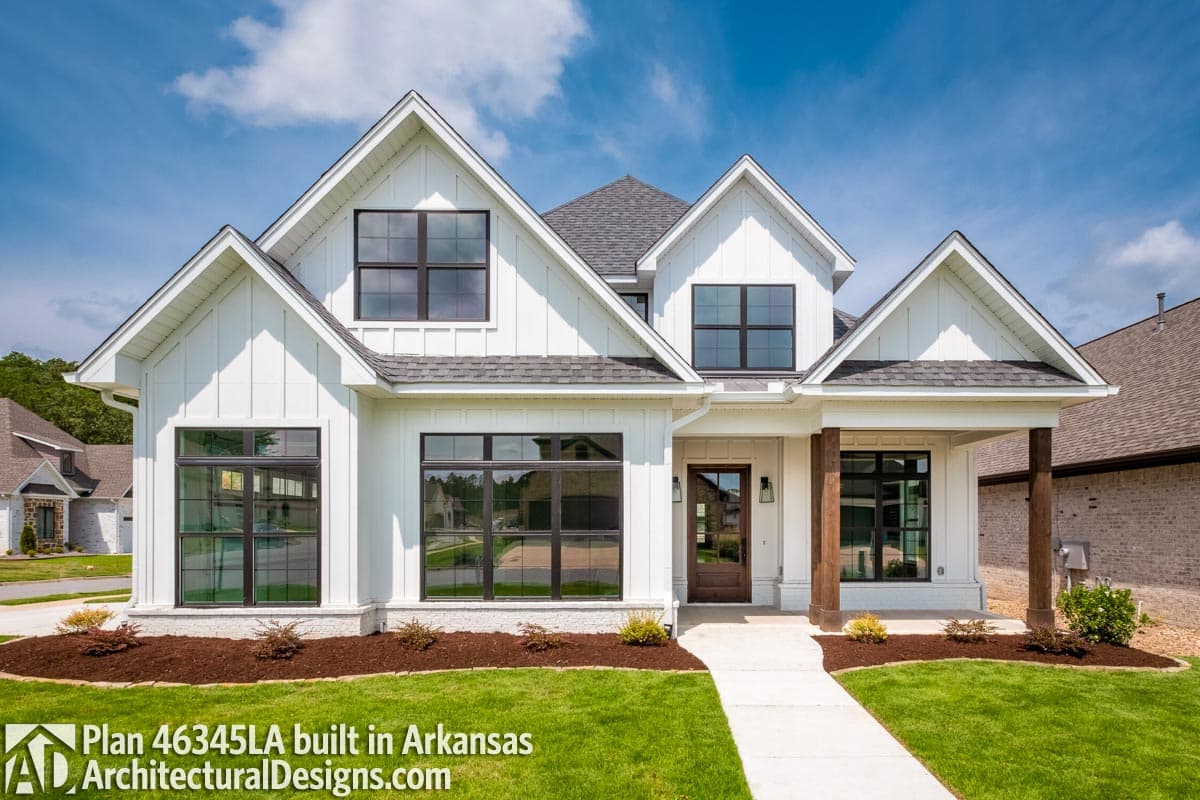 Modern Farmhouse style house plan exterior with board and batten siding, multiple gables, and a covered front porch with wood columns.