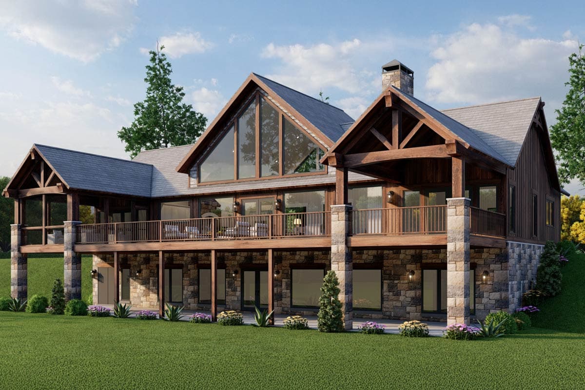 House plan exterior with stone base, wood siding, large gable window, covered deck, and exposed wood beams.