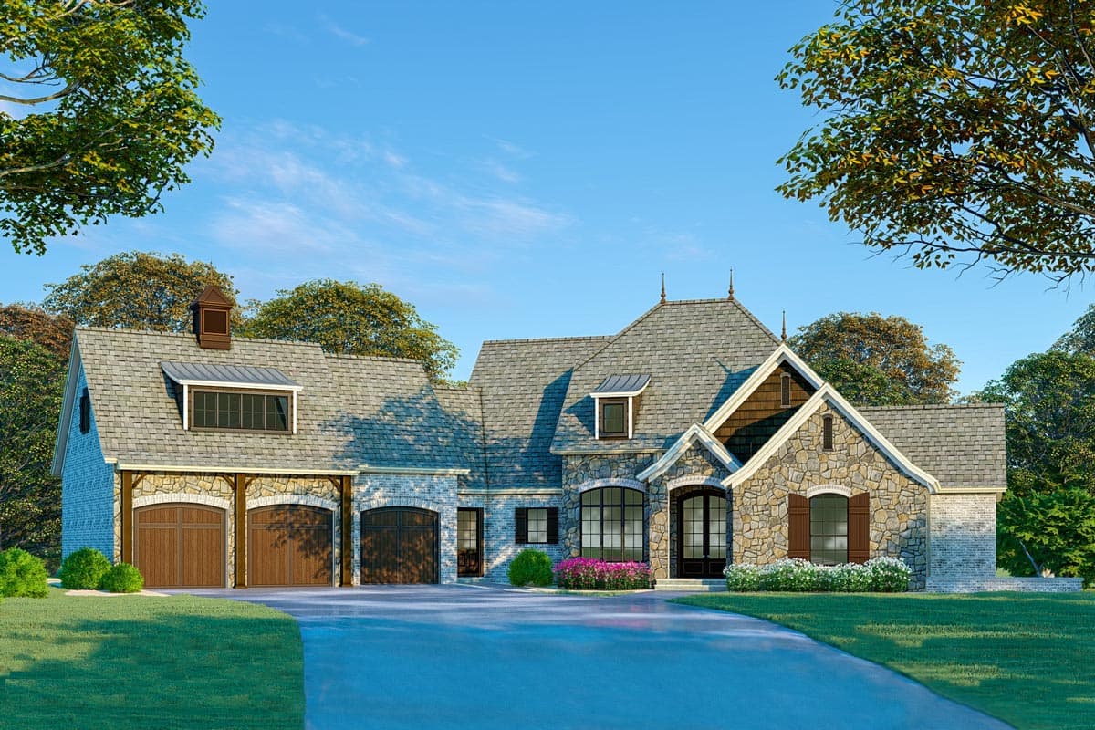 House plan exterior. Two-story French Country style home with stone facade, gabled roof, and attached garage with arched garage doors.
