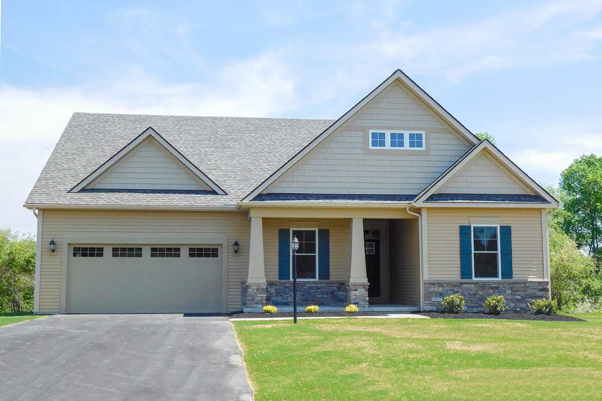 House plan exterior: Ranch style with a covered front porch, three gables, and a two-car garage.