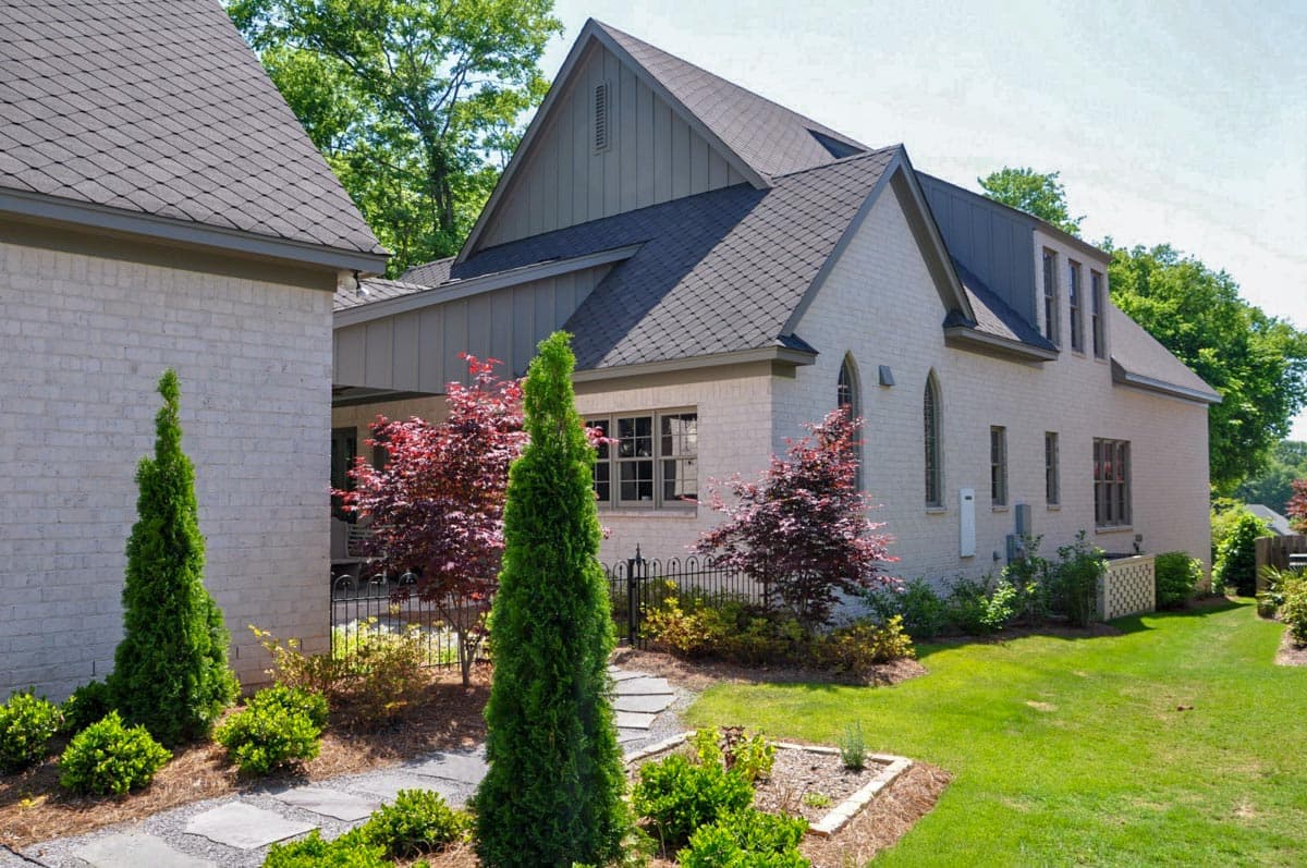 House plan exterior: Modern style, brick facade, multiple gables, and dormer windows.