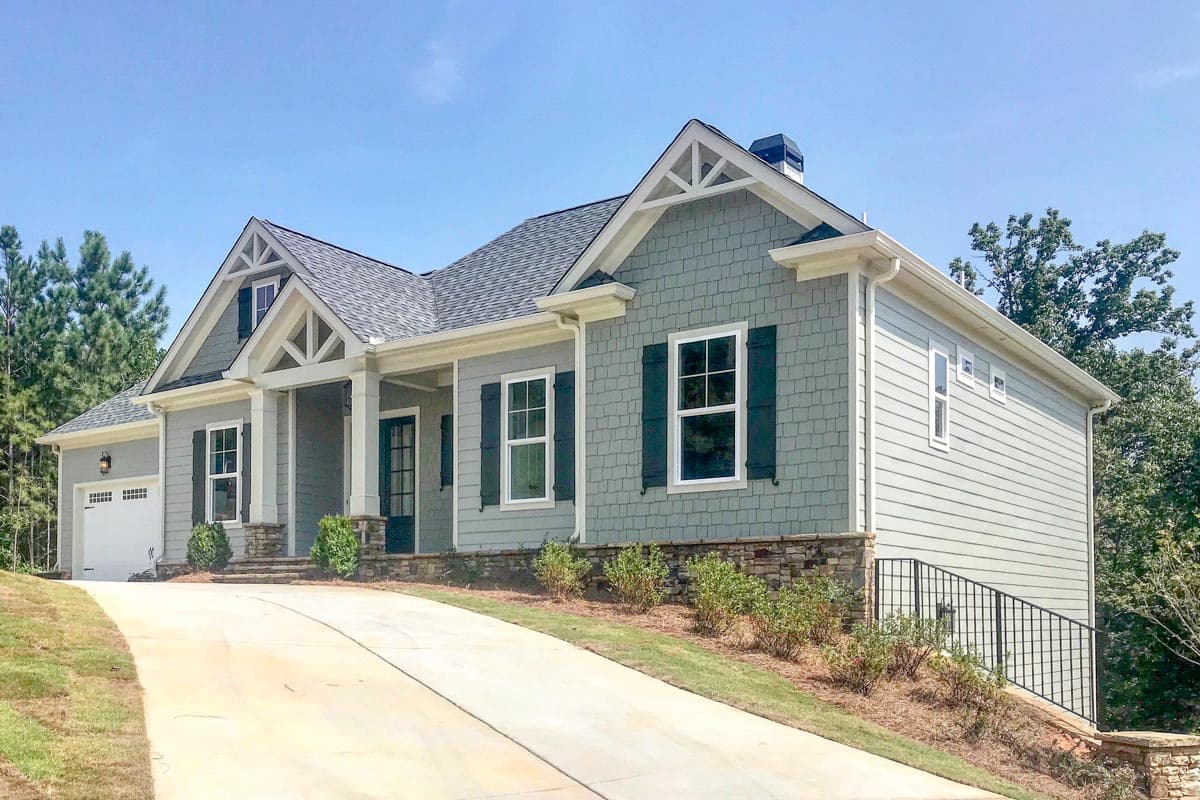 House plan exterior: Two-story Modern Farmhouse with gabled roof, front porch, and stone foundation.