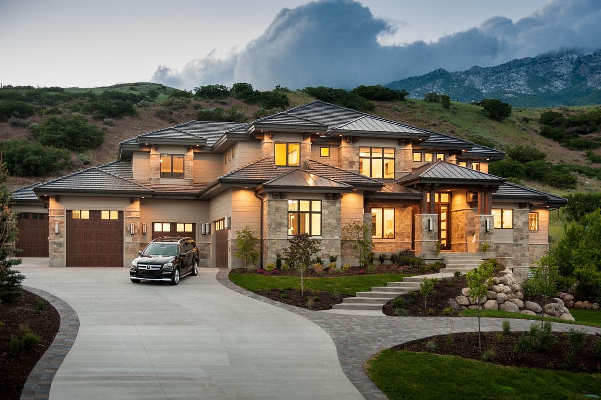 Modern house plan exterior with multiple gables, stone accents, a covered entry, and a three-car garage.