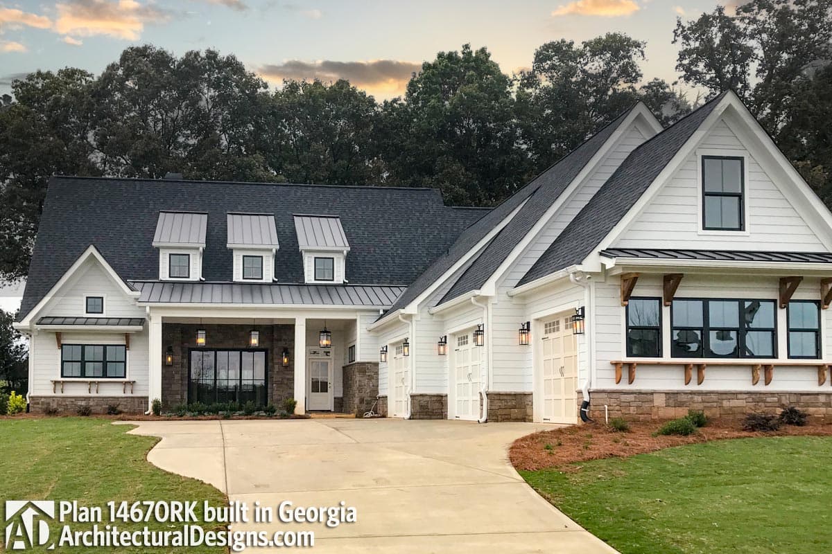 Modern Farmhouse house plan exterior with a covered porch, three dormers with metal roofs, and a three-car garage.