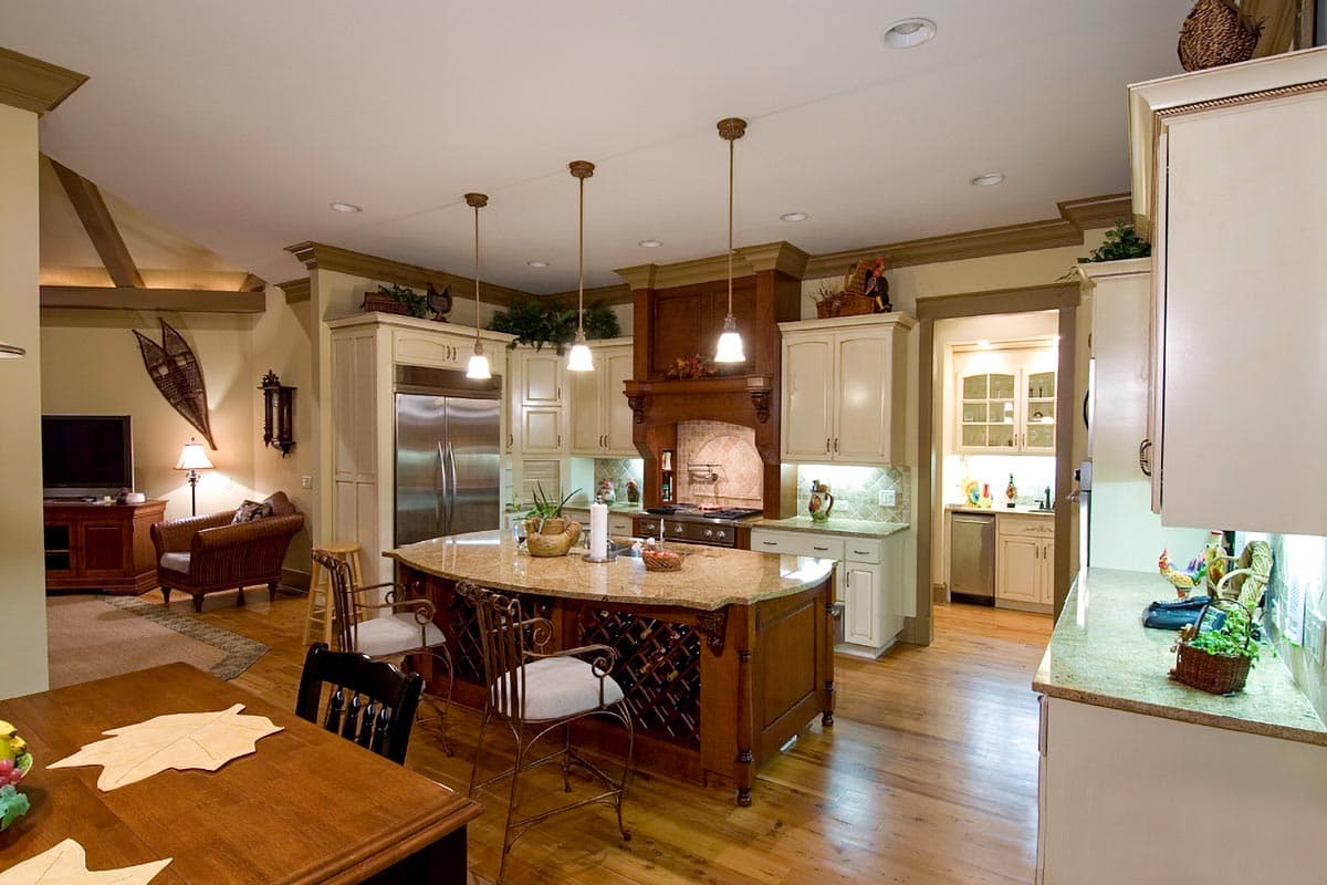 Spacious kitchen with large island, ample cabinetry, stainless steel refrigerator, and a butler's pantry.