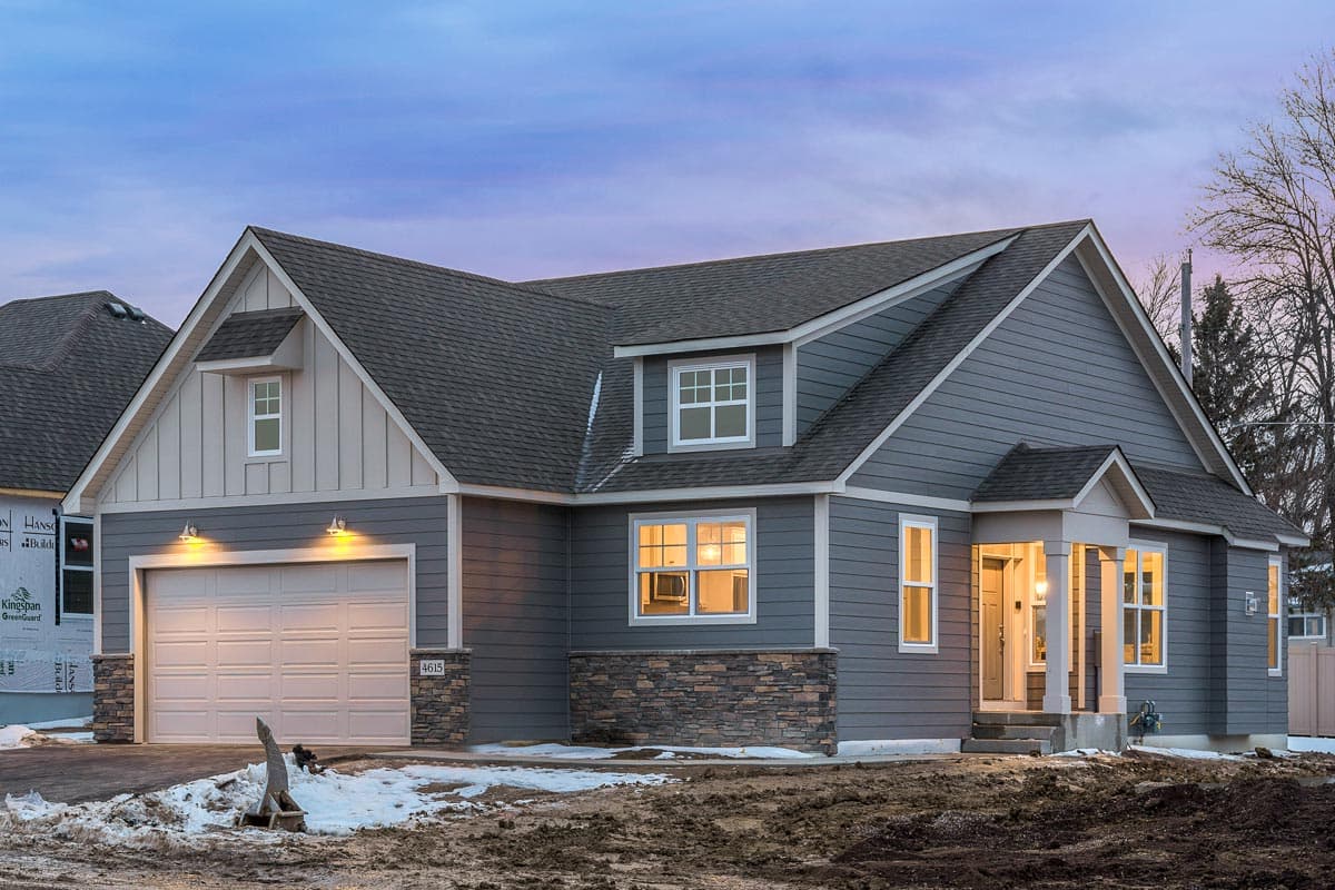 Modern Farmhouse style house plan exterior with a gabled dormer, stone accents, and a covered front entry.