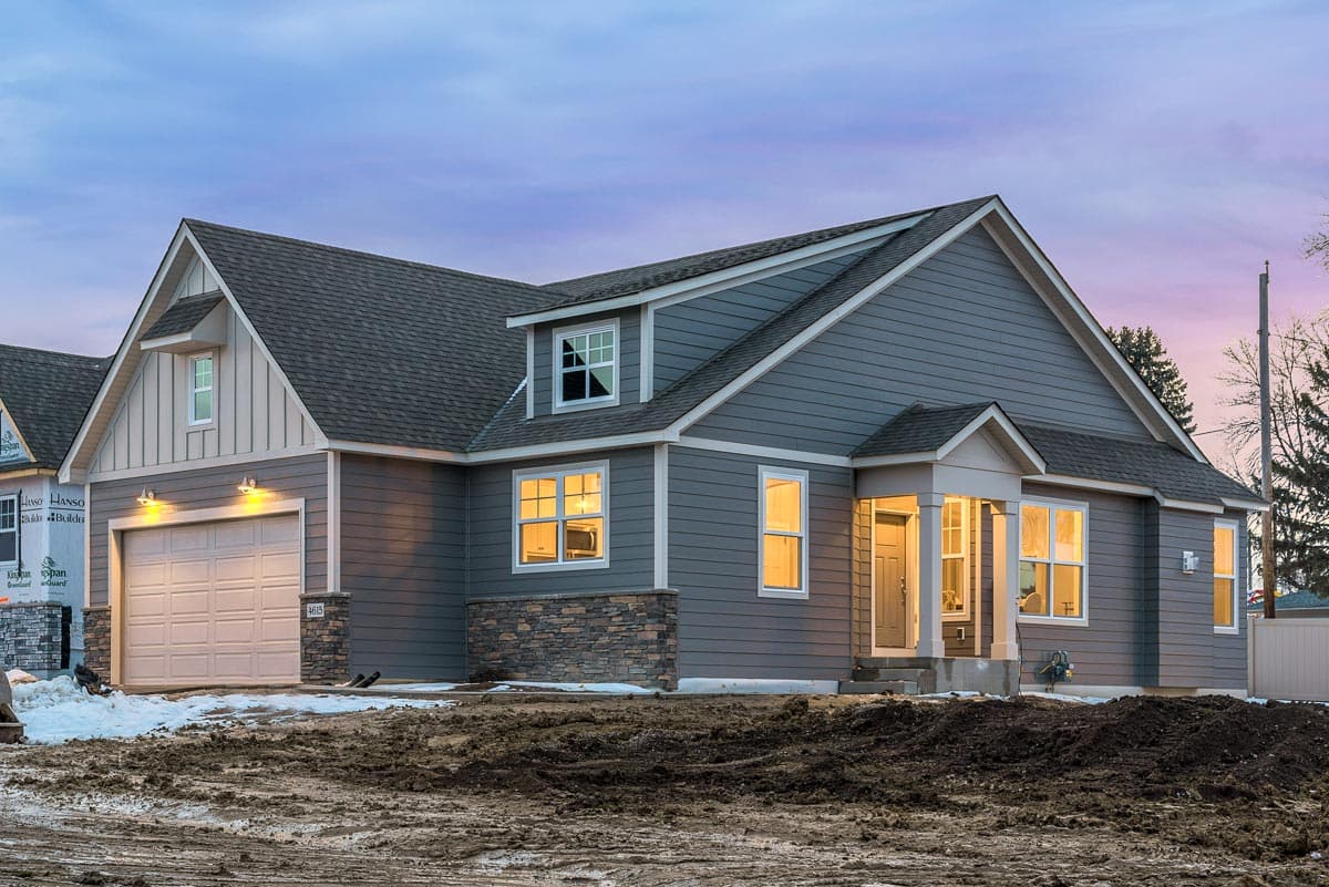House plan exterior: Modern Farmhouse style with gabled dormers, stone accents, and attached garage.