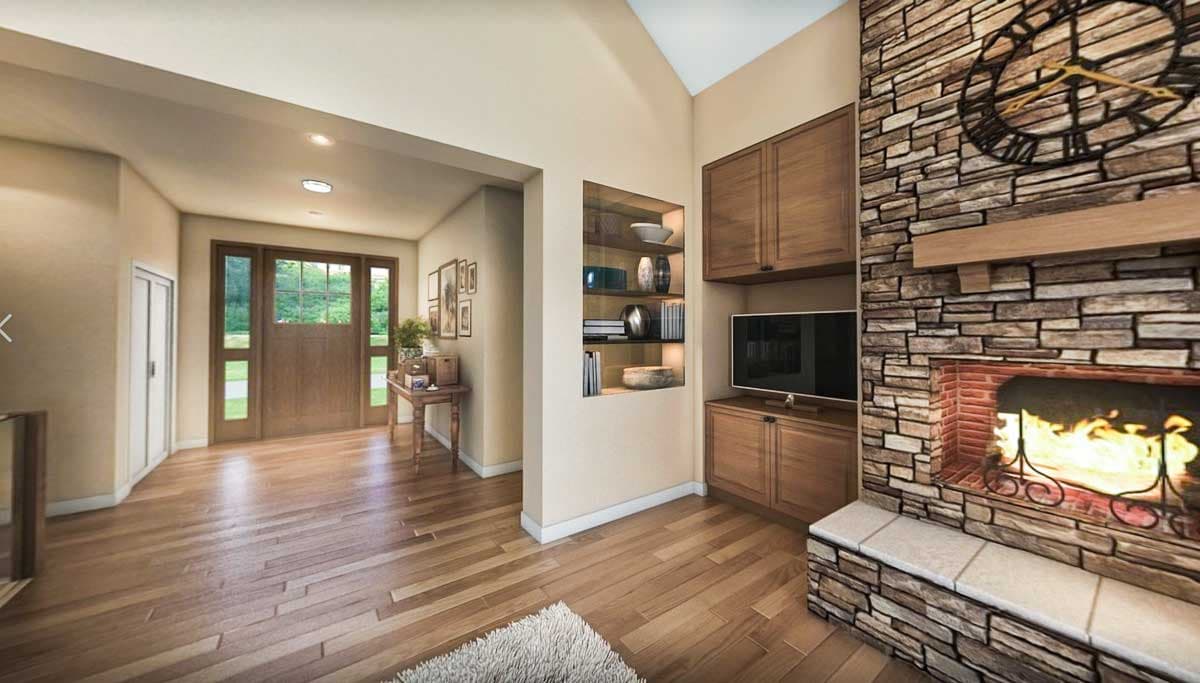 Interior view of a home entrance hall with hardwood floors, a stone fireplace, and built-in shelving.