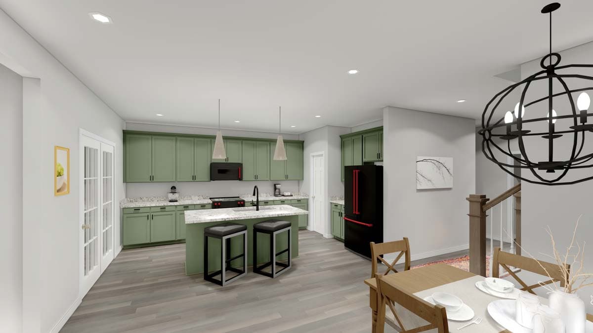 Kitchen with sage green cabinets, island with seating, black appliances, and dining area with modern chandelier.