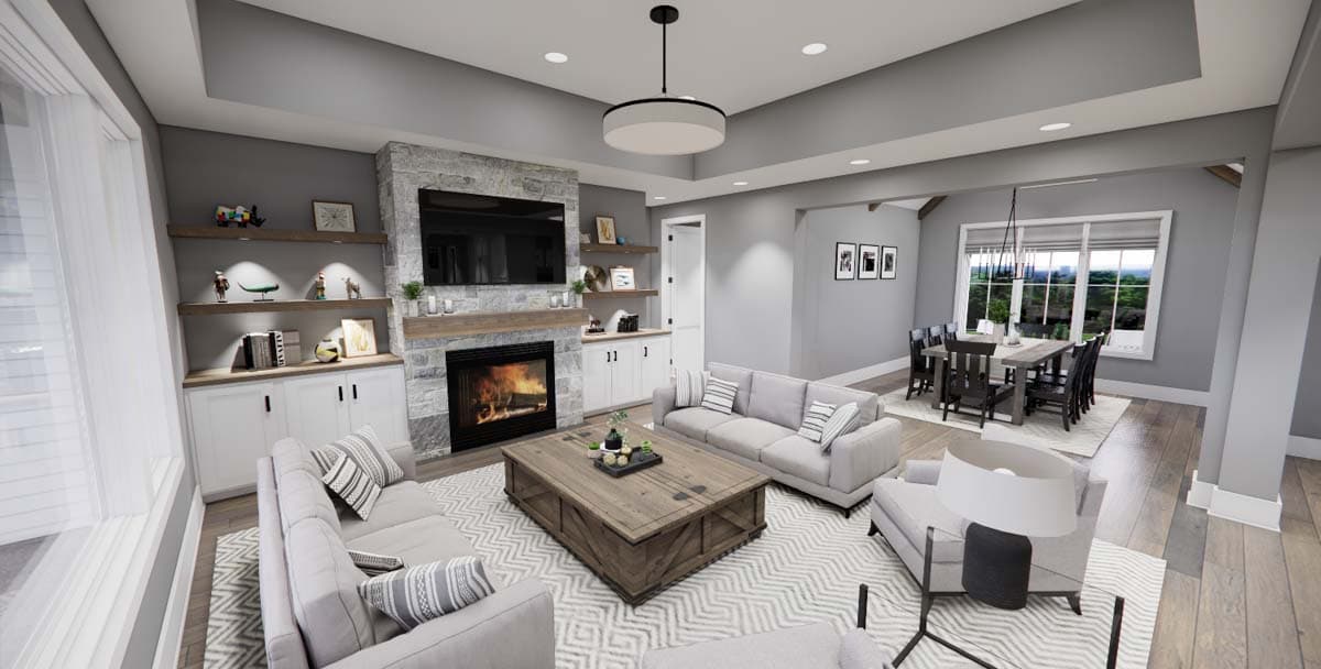 Living and dining area with stone fireplace, built-ins, coffered ceiling, and large windows.