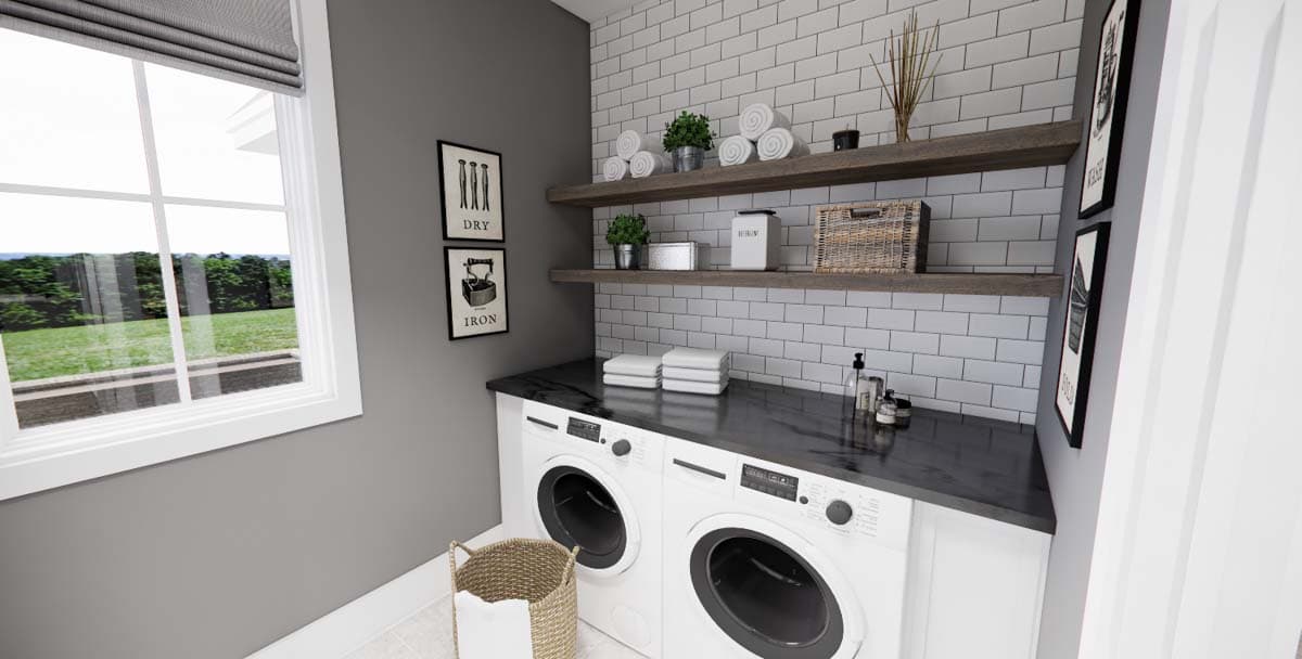 Laundry room interior with stacked washer and dryer, dark countertop, subway tile backsplash, and open shelving.