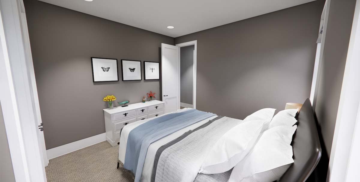 Bedroom with white dresser, framed butterfly art, and bed with blue and white linens.