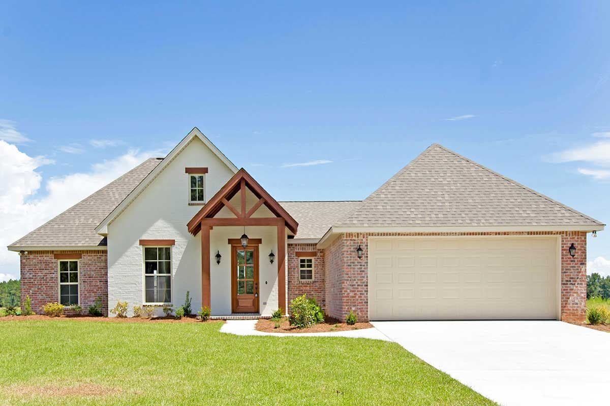 House plan exterior: One-story Modern Farmhouse with brick and stucco, covered porch with timber accents, and attached two-car garage.