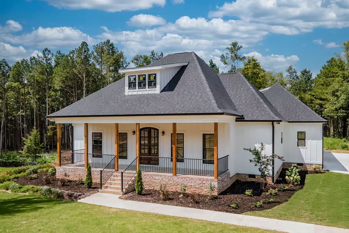 House plan exterior. Modern farmhouse style with porch, gables, and dormer. Features brick foundation, dark roof and white siding.