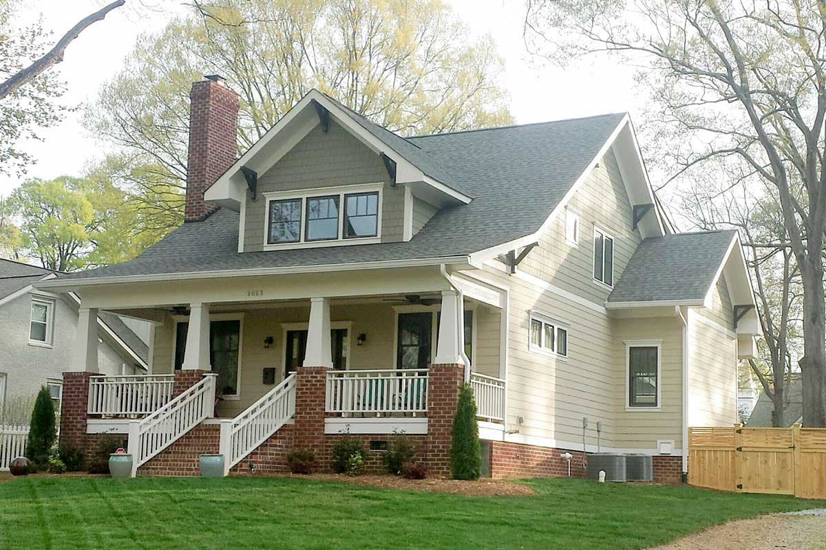 House plan exterior featuring Craftsman style, two stories, front porch with columns, gables, and brick chimney.