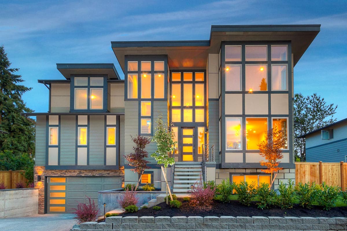 House plan exterior. Modern style, three-story home with flat rooflines, large windows, and an attached garage.