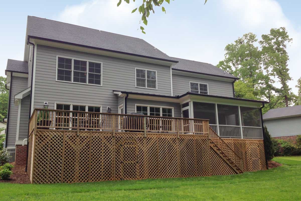 House plan exterior with siding, a large wooden deck with lattice skirting, and a screened-in porch.