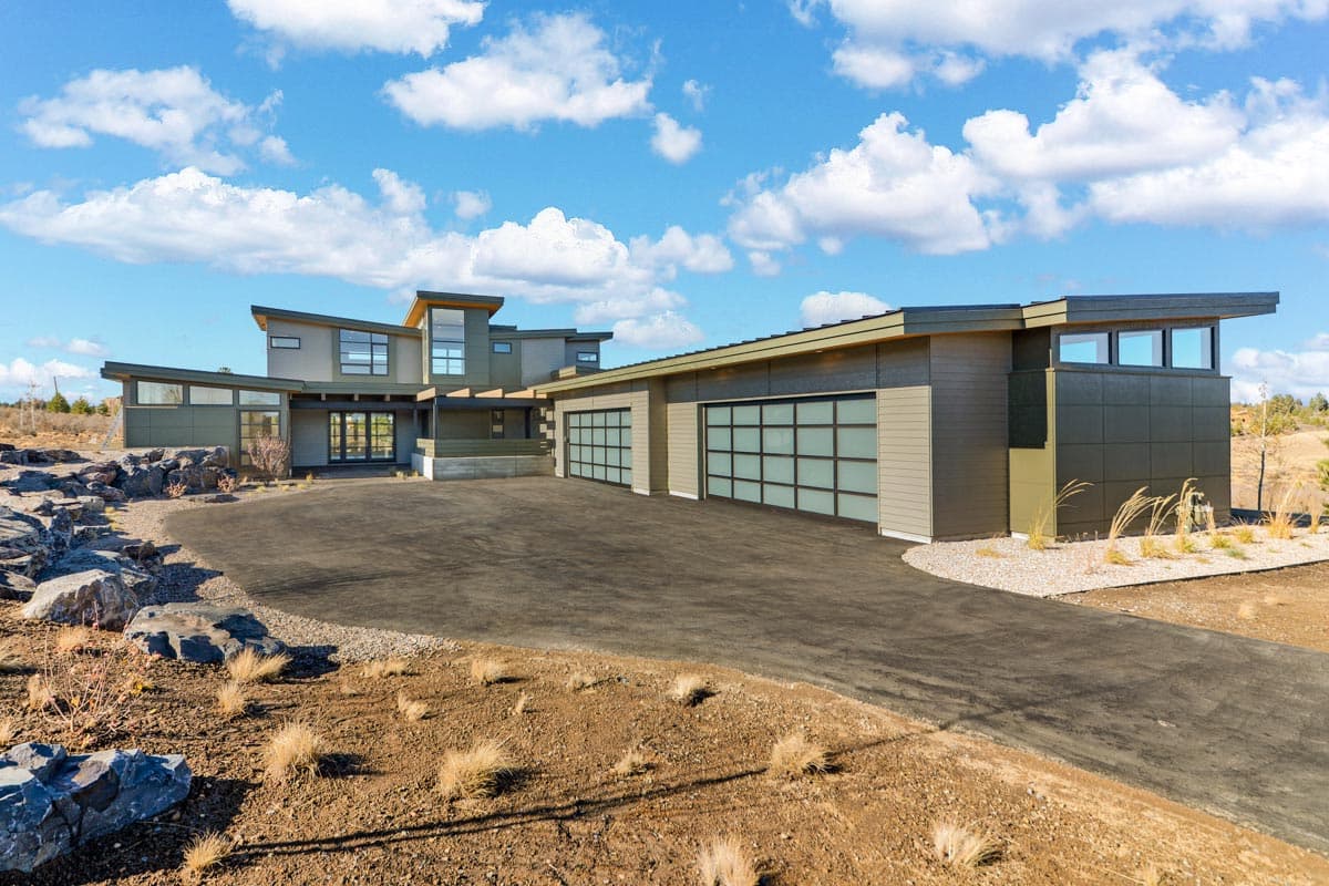 House plan exterior featuring Modern style, two stories, flat rooflines, large windows, and a multi-car garage.