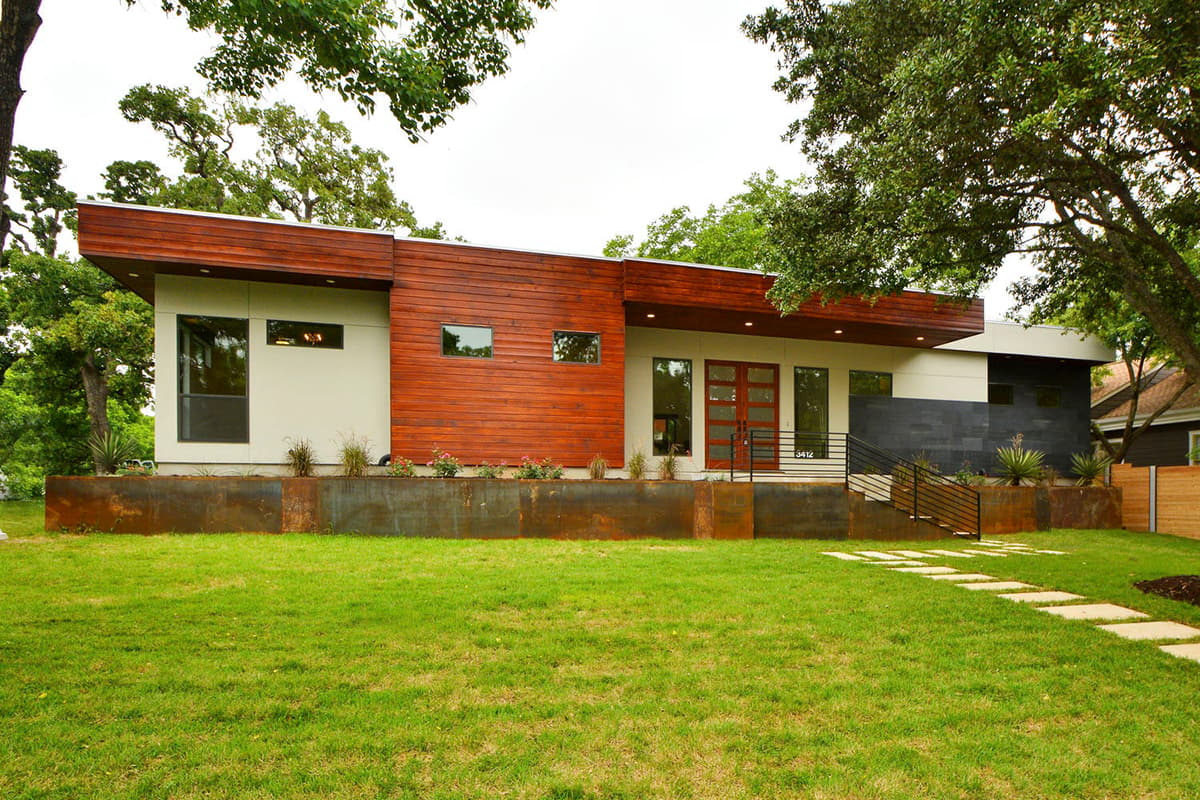 Modern house plan exterior with wood siding, flat roof, large windows, and a prominent cantilever.