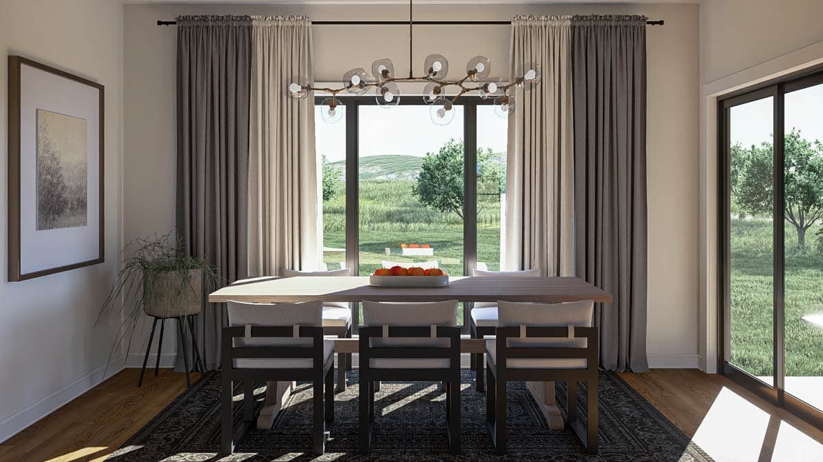 Dining area with a large table and chairs, a modern chandelier, and sliding glass doors opening to a yard.