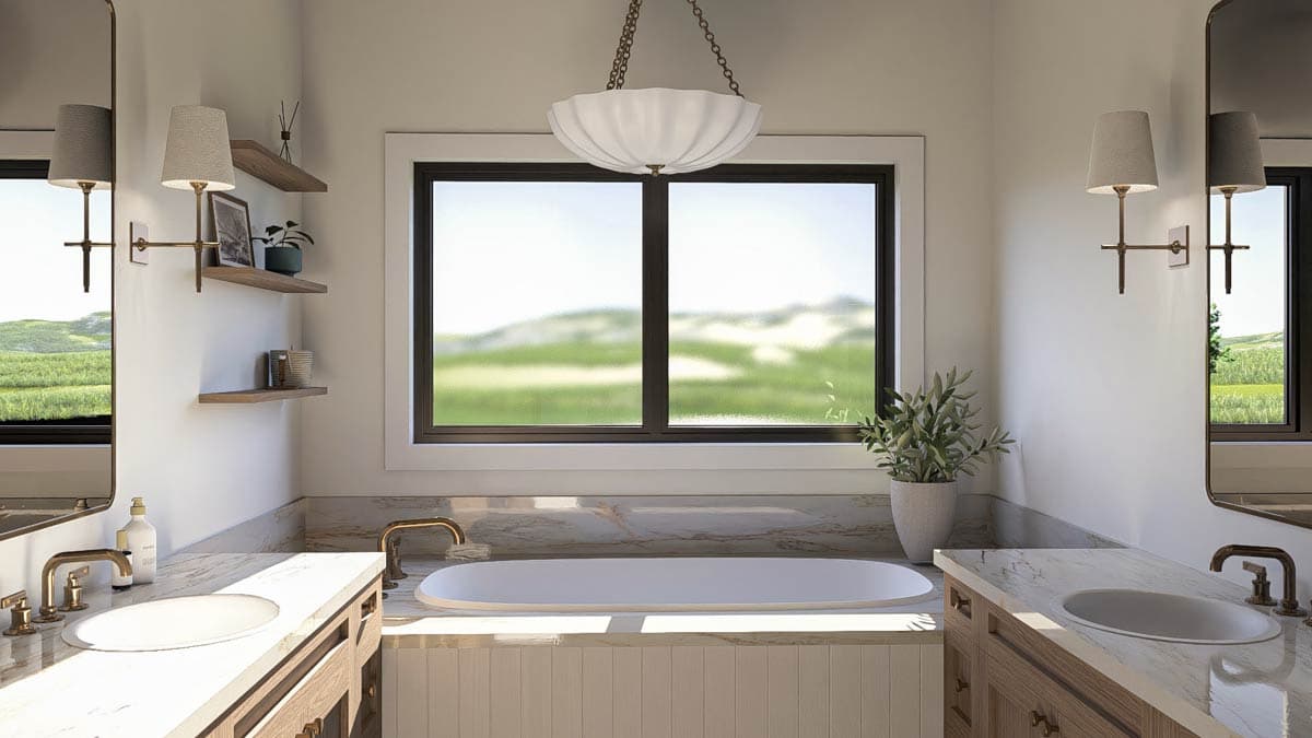 Bathroom with double vanity, freestanding tub, large window with exterior view, and decorative sconces.