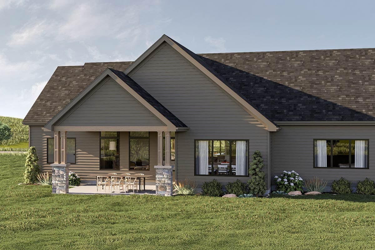 House plan exterior with a covered porch supported by stone-clad pillars, gabled rooflines, and multiple large windows.