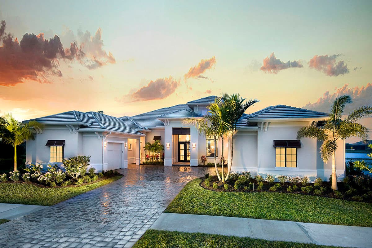 House plan exterior featuring a low-pitched roof, symmetrical facade, and covered entryway. A two-car garage is visible, along with a paver driveway.