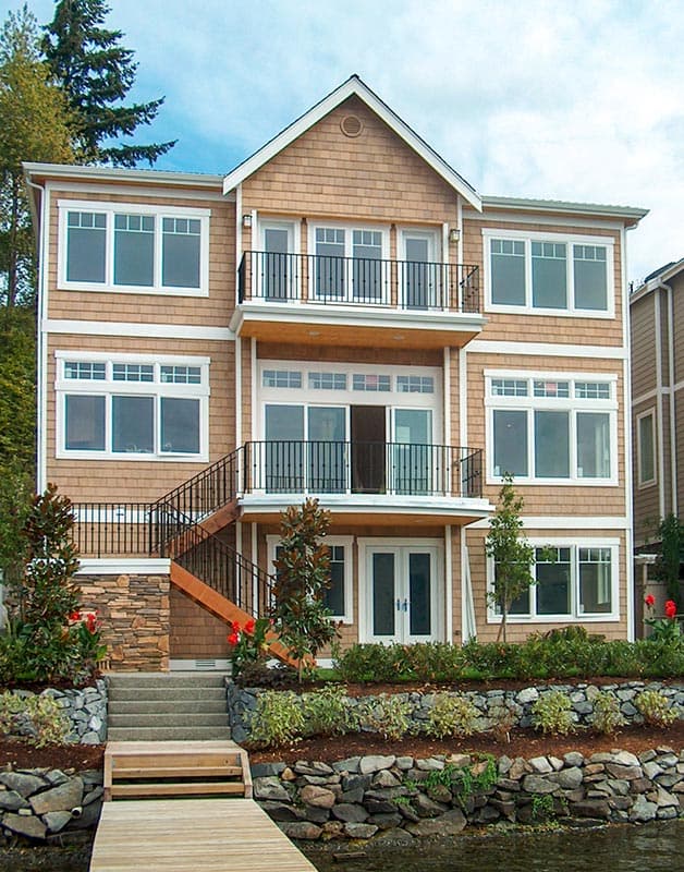 House plan exterior: three-story contemporary home with cedar shingles, multiple balconies, and large windows.