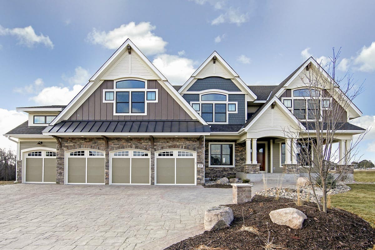 House plan exterior shows a large, multi-story home with a three-car garage, stone accents, and prominent gables.