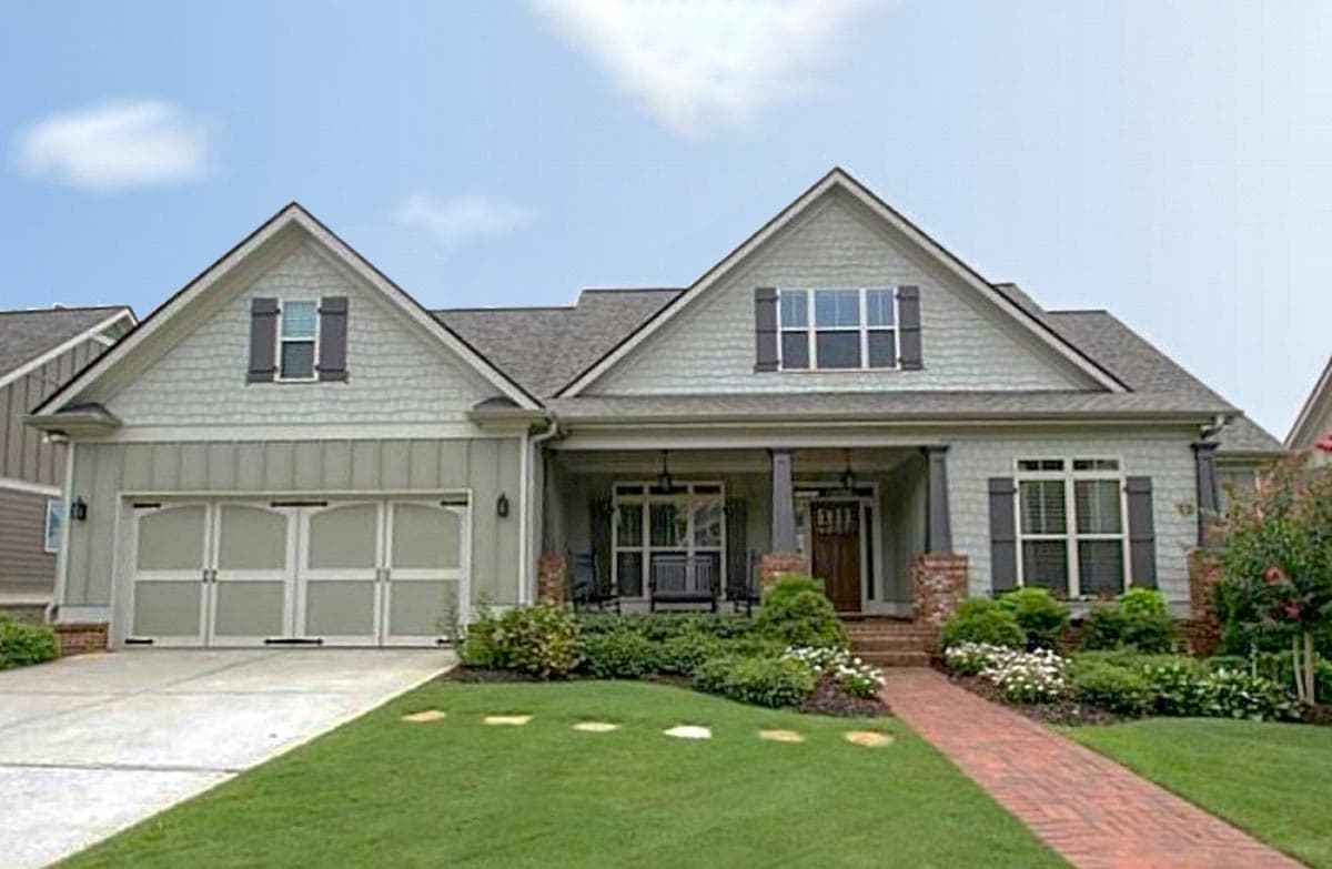 House plan exterior: One-and-a-half story Modern Farmhouse with a covered front porch, dual gables, and a side-facing garage.