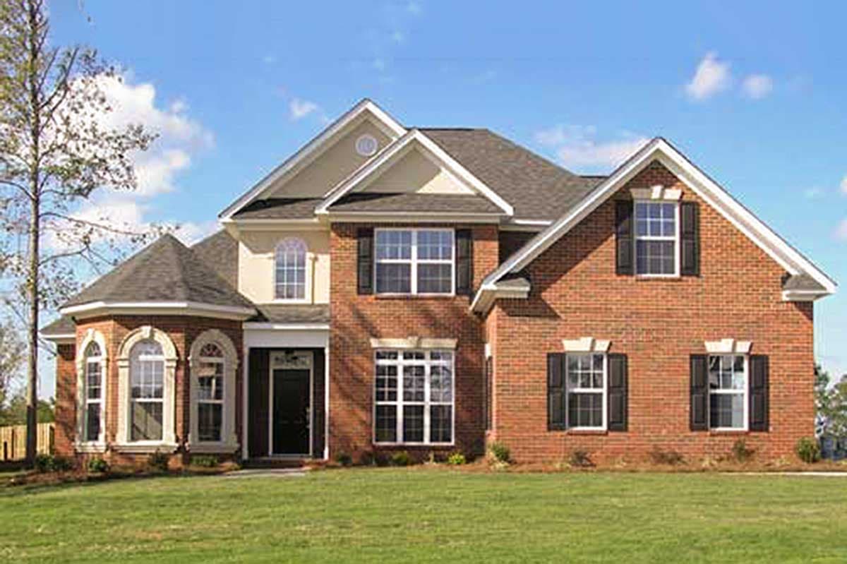 House plan exterior of a two-story brick home with a prominent gable, arched windows, and a covered entry.