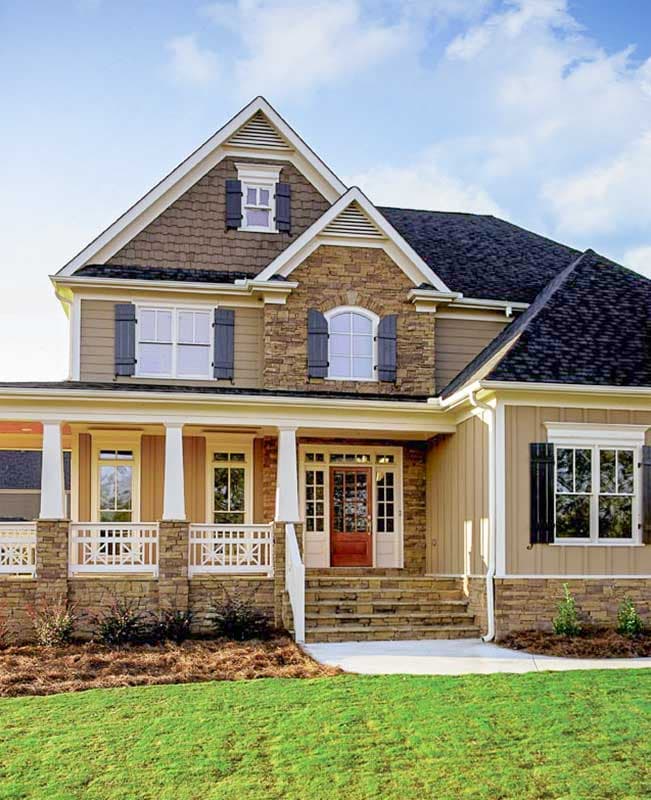House plan exterior shows a two-story home with a covered front porch, stone accents, multiple gables, and dormer windows.