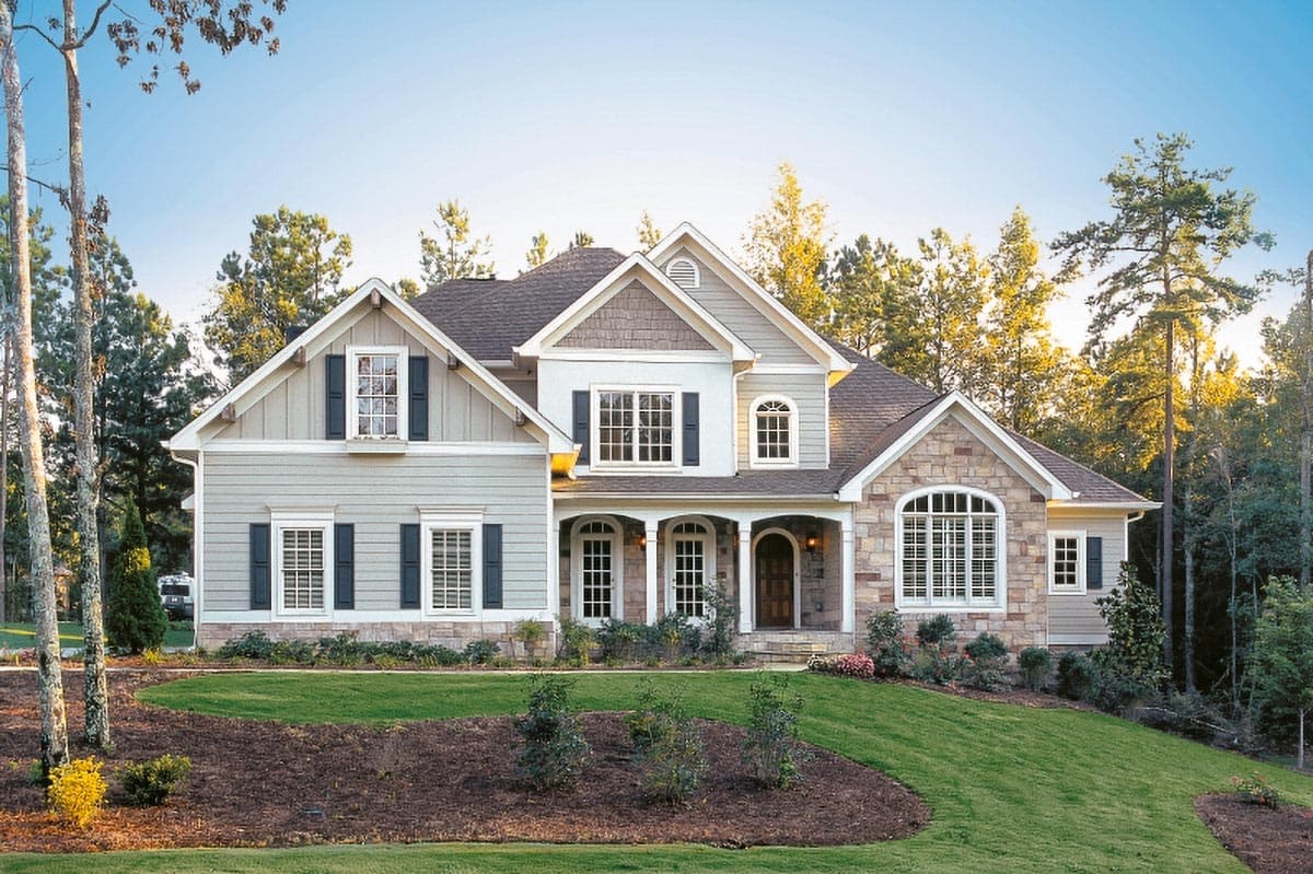 House plan exterior. Two-story home with Craftsman style, front porch, multiple gables, and stone accents on the facade.