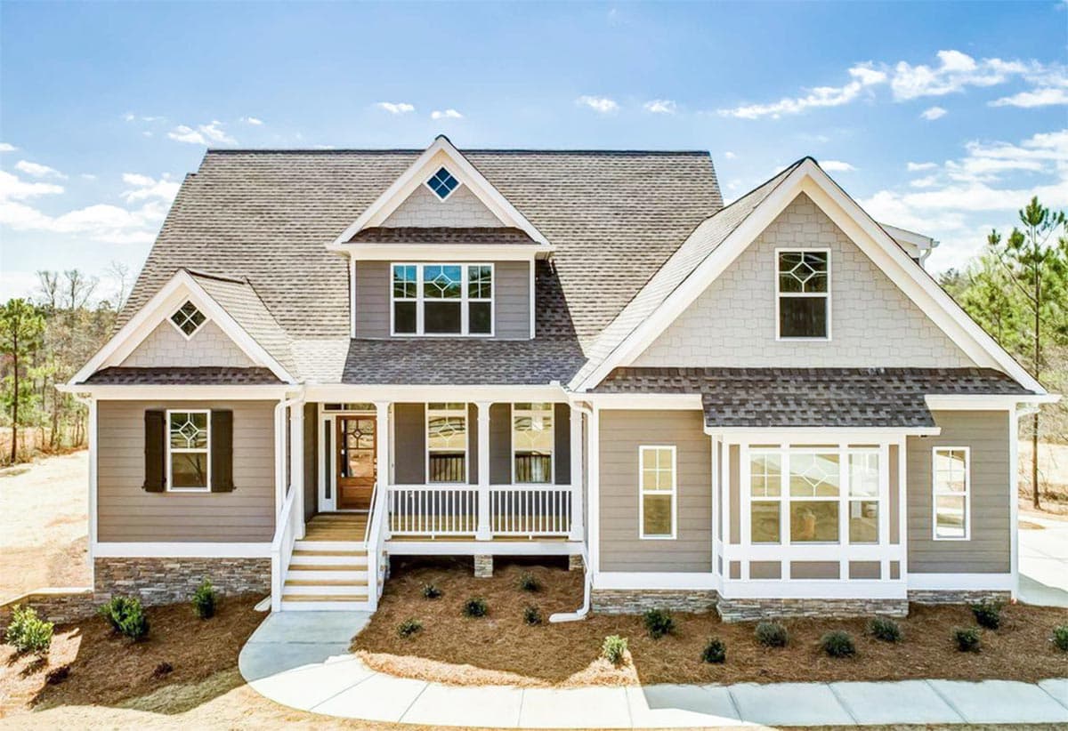 House plan exterior: Two-story Craftsman style with wrap-around porch, stone accents, bay window, and diamond dormer.