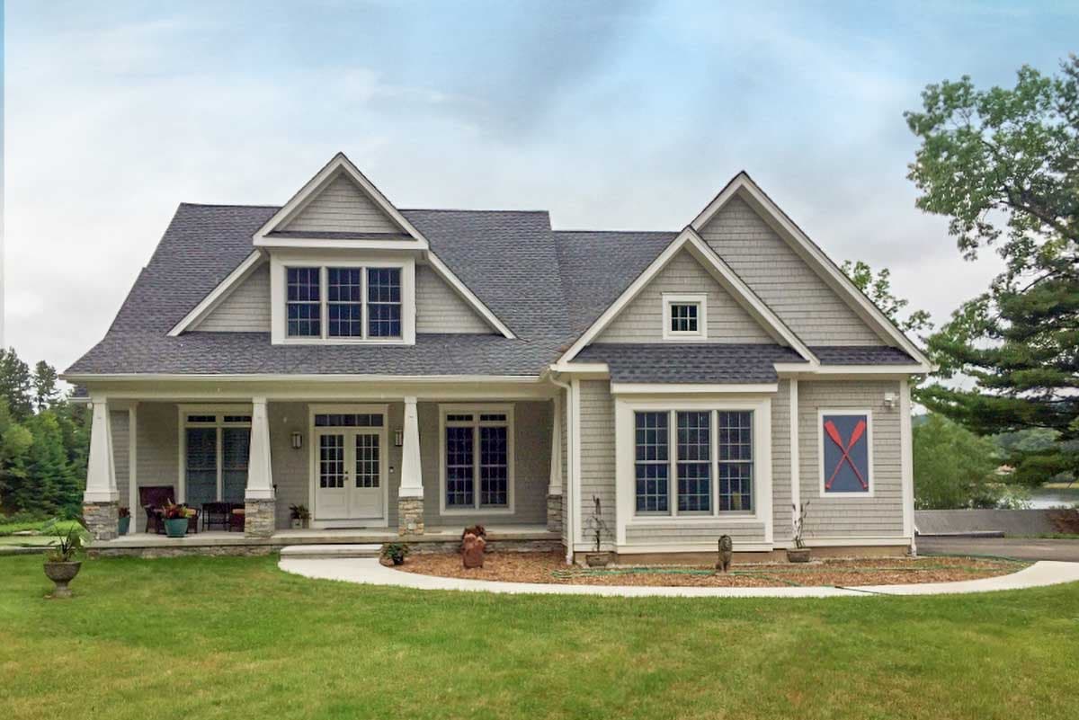 House plan exterior: One-story Modern Farmhouse with a covered porch, multiple gables, dormers, and shingle siding.